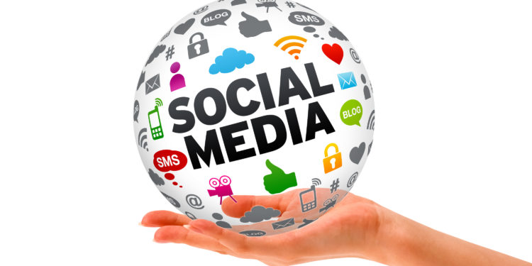 Hand holding a Social Media 3d Sphere sign on white background.